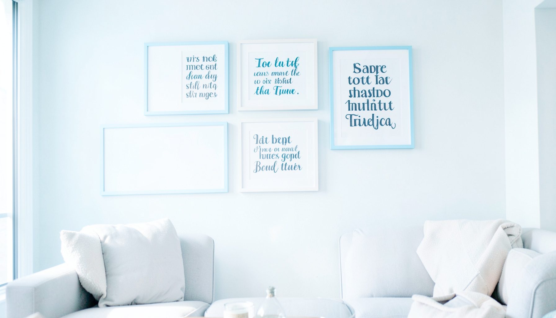 A living room wall featuring framed typographic art quotes in a clean, modern arrangement